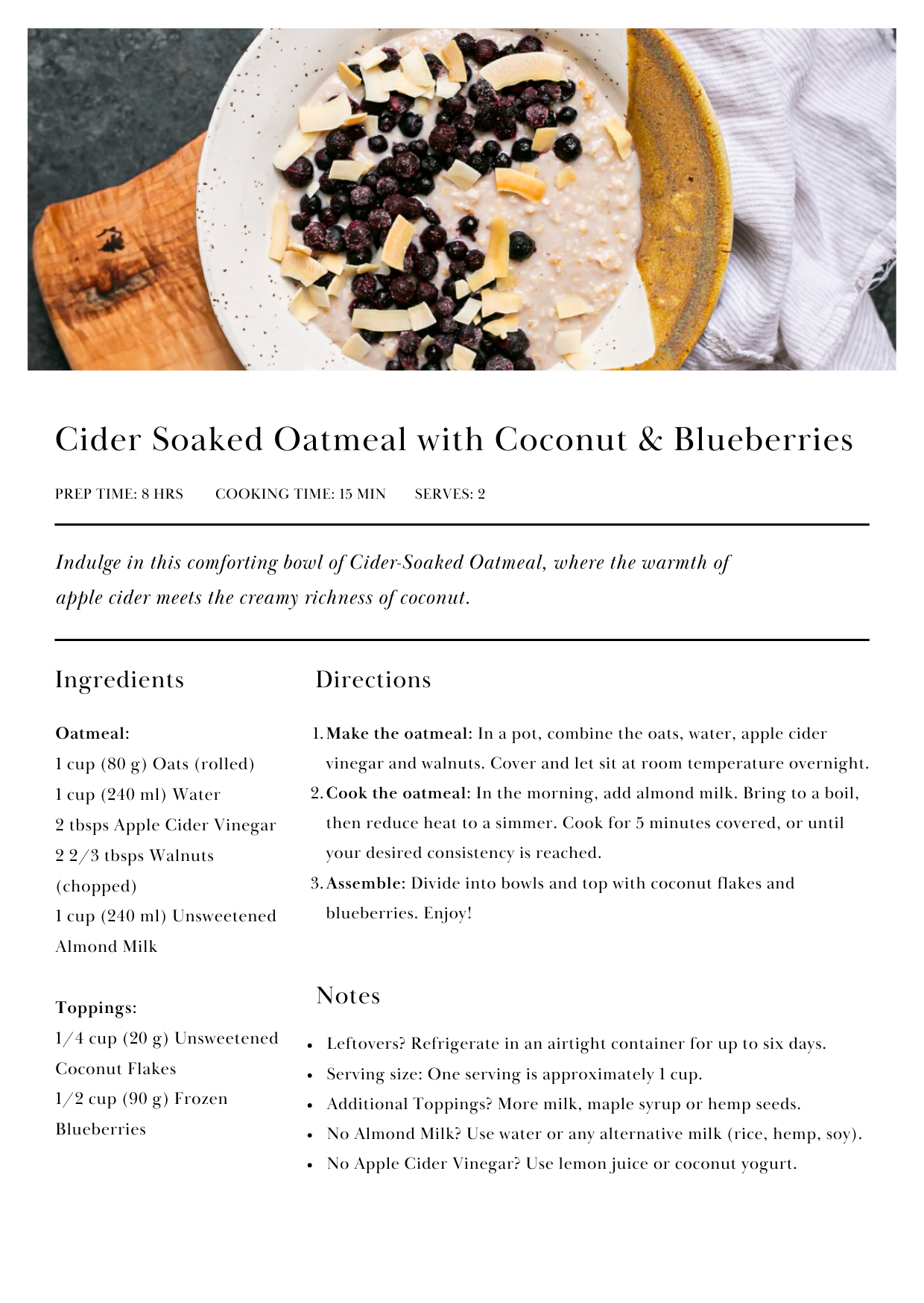 Low-FODMAP breakfast recipe featuring Cider Soaked Oatmeal with Coconut and Blueberries, served in a white bowl and garnished with a generous topping of coconut flakes and blueberries.